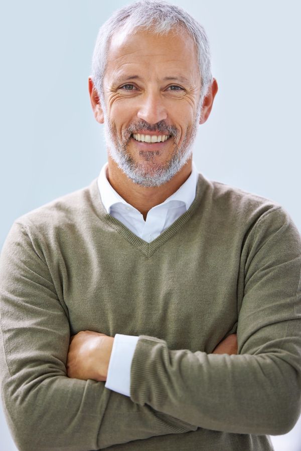 Confident man in a bright, modern setting.